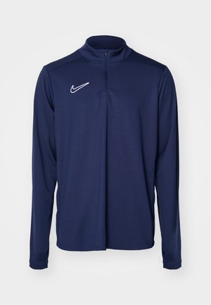 Navyblauer langärmeliger Sport-Pullover mit halbseitigem Reißverschluss und weißem Nike-Logo auf der Brust, aus einem glatten, leichten Material.