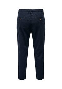 Pantalon bleu marine sur mesure avec deux poches passepoilées boutonnées à l'arrière et une ceinture, présenté de dos sur un fond blanc.