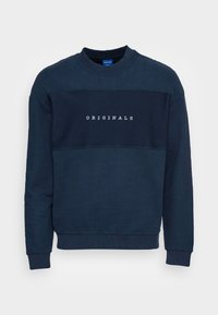 Felpa blu navy con colletto rotondo, caratterizzata da un pannello testurizzato e con la scritta "ORIGINALS" stampata in bianco sul davanti. Tessuto morbido.