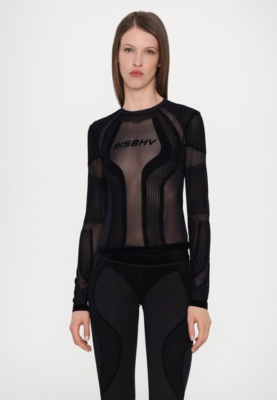 Black athletic top with long sleeves, featuring transparent mesh and textured stripes, branded with "MISBHV" across the chest.