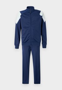Tuta blu navy realizzato in tessuto liscio; presenta una giacca con zip e dettagli a contrasto sulle spalle, abbinata a pantaloni coordinati.