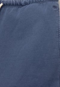 Pantaloni della tuta blu navy realizzati in morbido cotone, con una superficie texturizzata e una vita elasticizzata con cordoncino.
