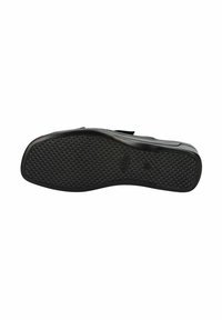 Suela de zapato de goma negra con un patrón de agarre texturizado, forma contorneada y bordes suaves, diseñada para la durabilidad y tracción.