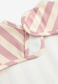 Striped fabric in pink and cream with a smooth texture, featuring rounded edges and visible stitching on the neckline.