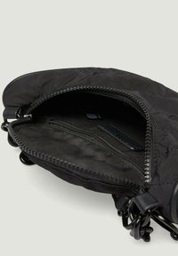 Czarna nylonowa torba o pikowanej fakturze. Posiada zamek błyskawiczny na górze oraz wewnętrzną kieszeń, zaprojektowaną z myślą o praktycznym przechowywaniu.