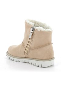 Stivali alla caviglia in suede tan con foderatura in pelliccia sintetica, chiusura con zip laterale e suola in gomma bianca dotata di un motivo a tassello per una migliore aderenza.