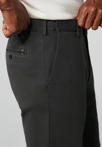 Donkergrijze broek met een slim fit, een gladde textuur, zijzakken en een achterzak met kleurrijke gestreepte accenten.
