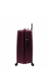 Hard shell suitcase in deep purple, featuring a zipper closure, retractable handle, and four black wheels for mobility.