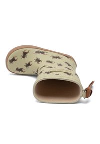 Botte de pluie beige pour enfant avec semelle marron et languette, décorée d’illustrations de lucane cerf-volant brun foncé.
