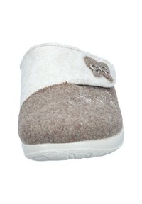 Brown and beige felt slipper with a strap and decorative button. Features a white sole and subtle floral embroidery on the toe.