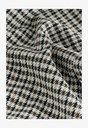 Woven fabric in a houndstooth pattern featuring black, white, and brown tones; soft texture with visible folds and draping.