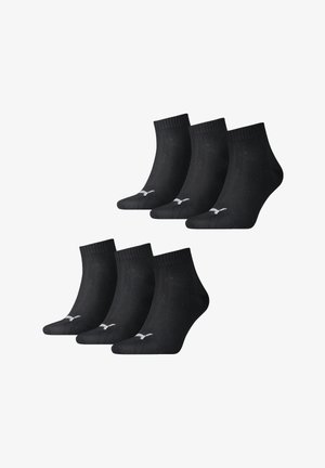 Black ankle socks in a pack of six. Made of soft fabric with a ribbed cuff. Features a small white logo on the toe.