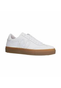 White synthetic sneakers with a smooth upper, featuring a textured tan rubber sole, decorative stitching, and a stylized logo on the side.