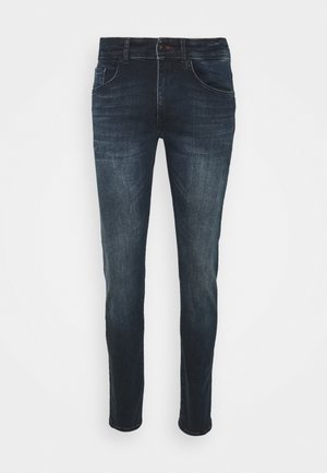 Jeans in denim blu scuro con un fit slim, cinque tasche, chiusura con bottoni e una leggera scoloritura lungo le gambe, caratterizzati da una texture liscia.