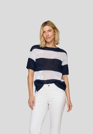 Navy and white striped knit top, featuring a loose fit, short sleeves, and open weave texture. Paired with white pants.