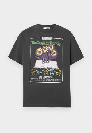 Black t-shirt with a graphic of yellow and purple flowers in an open book and colorful smiling sun shapes below, featuring "The Coach for Everyday." text.
