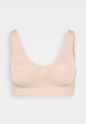 Sømløs, trådløs bh i lys beige, lavet af blød strækstof. Bredde stropper og en rund halsudskæring. Subtil tekstur uden lukninger.