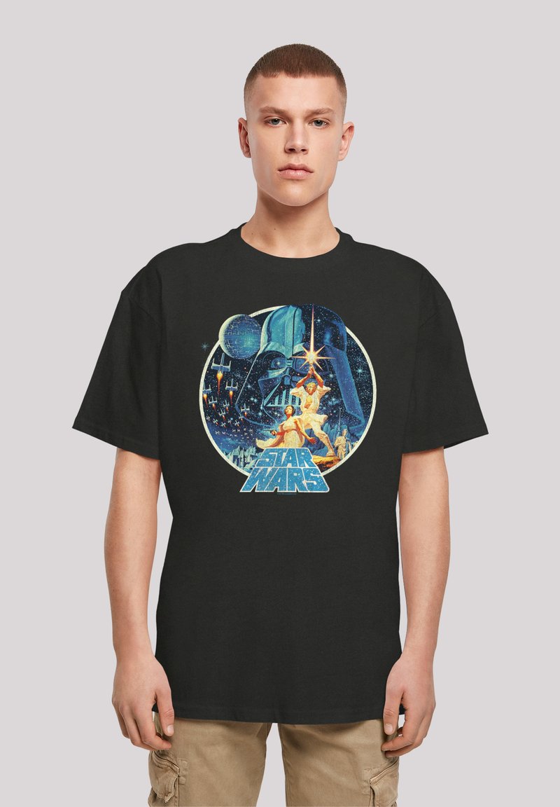 Black T-shirt featuring a colorful Star Wars graphic with characters and a helmet, round design, vibrant colors, and detailed artwork.