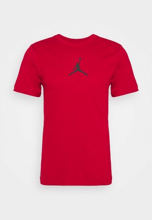 T-shirt di cotone rosso con maniche corte, dotata di un logo Jordan nero centrato sul davanti. Design semplice con collo rotondo.