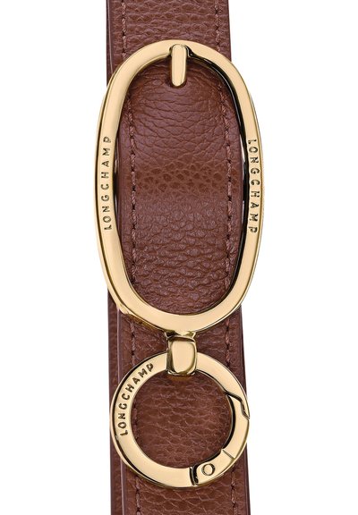 Brown leather strap featuring a large, oval gold-tone buckle engraved with "LONGCHAMP" and a circular gold ring detail below.