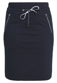 Marineblaue, taillierterock mit elastischem Bund, ausgestattet mit zwei aufgesetzten Taschen mit Reißverschluss auf der Vorderseite und einem glatten, strukturierten Stoff.