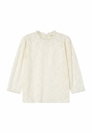 Haut en dentelle blanc cassé avec de longues manches bouffantes et un ourlet à volants. Présente un motif floral sur l'ensemble et une fermeture clé au dos.