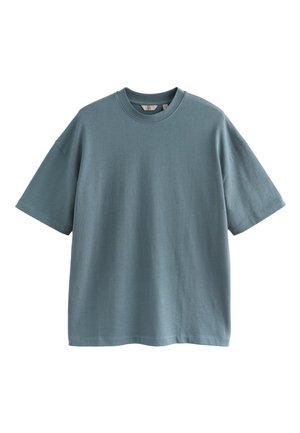 Baumwoll-T-Shirt im Oversize-Stil mit kurzen Ärmeln in einem gedämpften Türkis. Verfügt über einen Rundhalsausschnitt und ein nahtloses Schulterdesign.