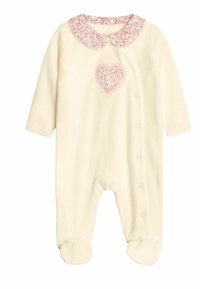 Cremfarbener Overall mit langen Ärmeln, strukturiertem rosa Kragen, Herzdesign auf der Brust, Druckknopfverschluss vorne und Füßchenboden.