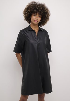 Black, short-sleeved dress made of a smooth, glossy material, featuring a collared neckline and a front zipper detail.