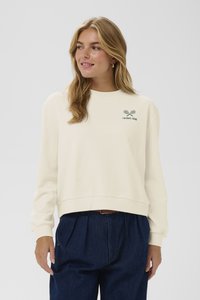 Felpa crema con colletto a girocollo a costine, maniche lunghe e logo di una racchetta da tennis ricamato in verde scuro. Presenta una vestibilità rilassata.