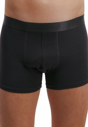 Schwarze Baumwoll-Boxershorts mit einem glatten Bund und passgenauer Passform, ausgestattet mit einer konturierten Tasche und kurzen Beinen.