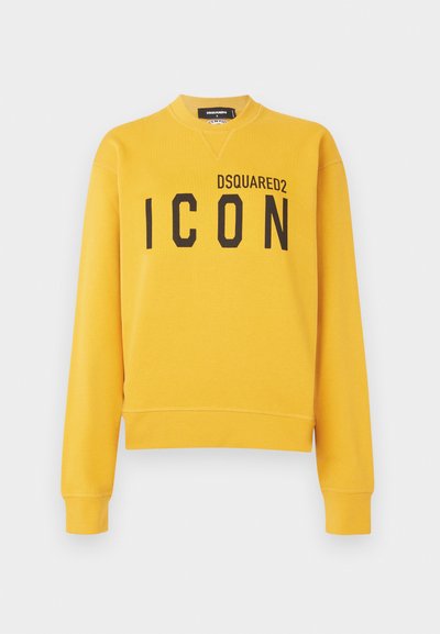 Sudadera amarilla de algodón, con cuello redondo, mangas largas y un gran estampado negro de "ICON" en la parte frontal.