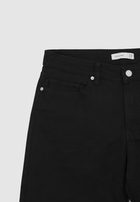 Pantalons en denim noir avec fermeture à bouton, passants de ceinture et poche avant. Le tissu a une texture lisse avec un motif côtelé subtil.