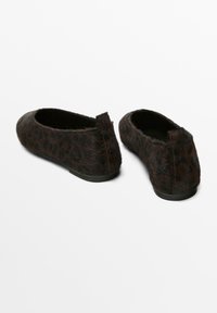 Brown leopard print ballet flats with fur texture, rounded toe, and low black rubber sole. Features a short back heel.