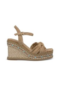 Beige wedge sandals with a knotted suede upper, woven jute base, and decorative turquoise stones along the midsole. Adjustable ankle strap.