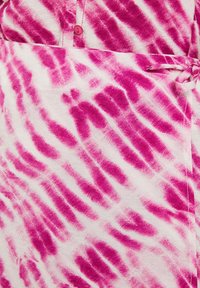 Pink and white patterned fabric with a tie detail and a button closure, featuring a textured, abstract design in a stripe formation.