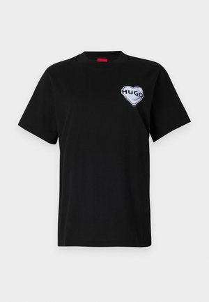 Black cotton t-shirt featuring a round neckline and short sleeves, with a white heart-shaped "HUGO" logo on the left chest.