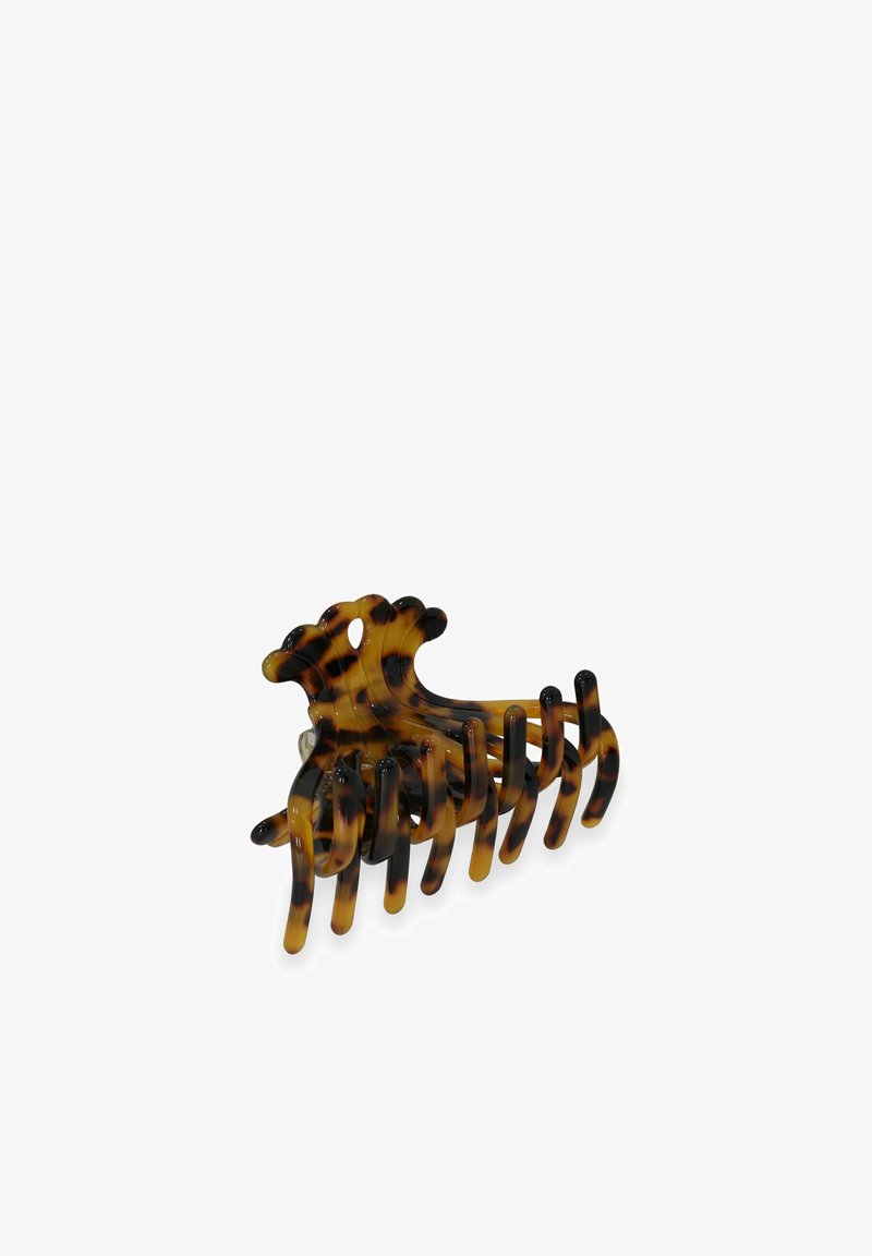 Fibbia per capelli in tartaruga realizzata in plastica, caratterizzata da denti ampi e un design arrotondato, con una finitura lucida e motivi alternati chiari e scuri.