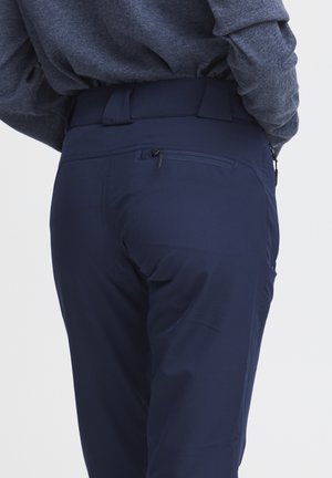 Navy blue pants with a smooth texture and a slim fit. Features a zippered back pocket and a flat waistband for comfort.