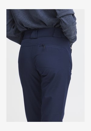Navy blue pants with a smooth texture and a slim fit. Features a zippered back pocket and a flat waistband for comfort.