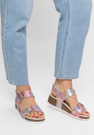 Colorful, metallic sandals featuring two adjustable straps and a wedge cork sole. The upper has a textured, multicolored pattern with a silver buckle.