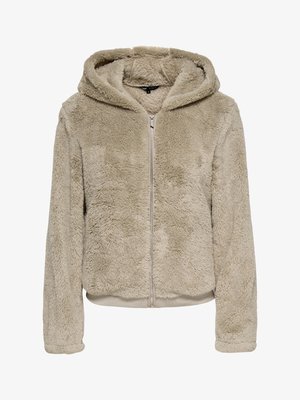 Beige zip-up hoodie made of soft, textured fleece. Features a hood, long sleeves, and ribbed hem and cuffs. No visible logos.