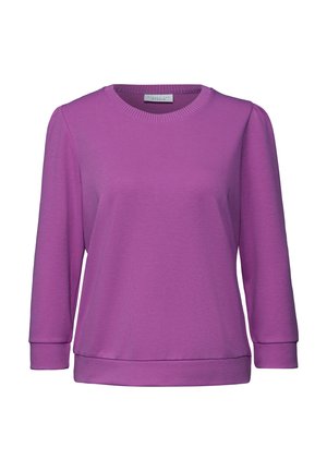 Lilla langærmet sweatshirt lavet af blødt materiale. Har rund halsudskæring og ribbede manchetter med en afslappet pasform. Glat, tekstureret overflade.