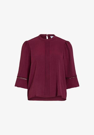 Bordeauxfarbene Bluse mit Biesen-Details vorne, 3/4 Puffärmel mit Paillettenbesatz und hohem Rundhalsausschnitt mit Knopfleiste hinten.