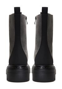 Gray suede ankle boots with a black rubber sole, zipper closure, and pull tab. Features contrasting textures and a chunky design.