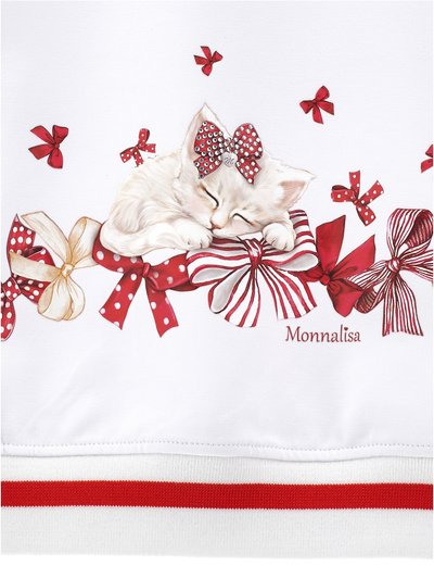 Una tela blanca presenta a un gato blanco dormido adornado con un lazo joya, rodeado de lazos y cintas rojas en una banda decorativa.