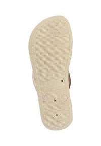 Suola di scarpa con una texture a righe, di colore crema, caratterizzata da tre punti circolari e un'etichetta di dimensione stampata, forma leggermente curva.