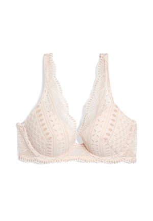 Bralette en dentelle dans une douce teinte pêche, présentant des bonnets triangulaires, des bords festonnés et des motifs de feuilles complexes sur le tissu.