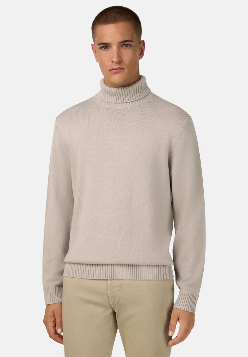 Šviesiai smėlinės spalvos megztinis su aukštu raugintų apykaklės kraštu ir raugintomis rankogaliais bei apačia. Reguliaraus silueto, su tekstūruotu paviršiumi.