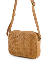 Tan woven leather crossbody bag with a rectangular shape, textured woven front, smooth back, and an adjustable strap with gold hardware accents.